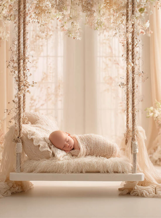 Newborn baby posed in a cosy floral nest, Melbourne newborn and maternity photography