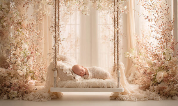 Newborn baby posed in a cosy floral nest, Melbourne newborn and maternity photography
