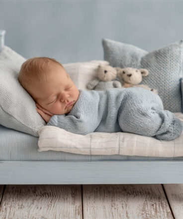 Tiny newborn nestled in a knitted layer, Melbourne newborn photography